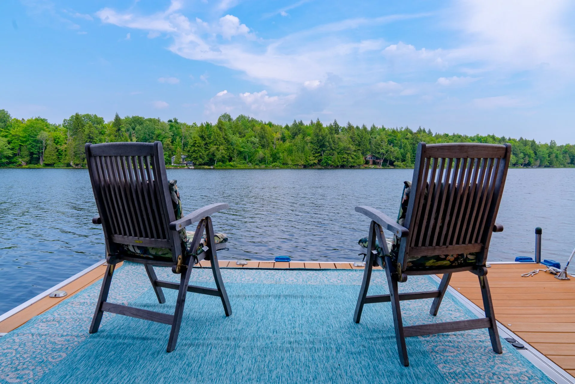 Chairs looking over Manhanock Pond from the dock