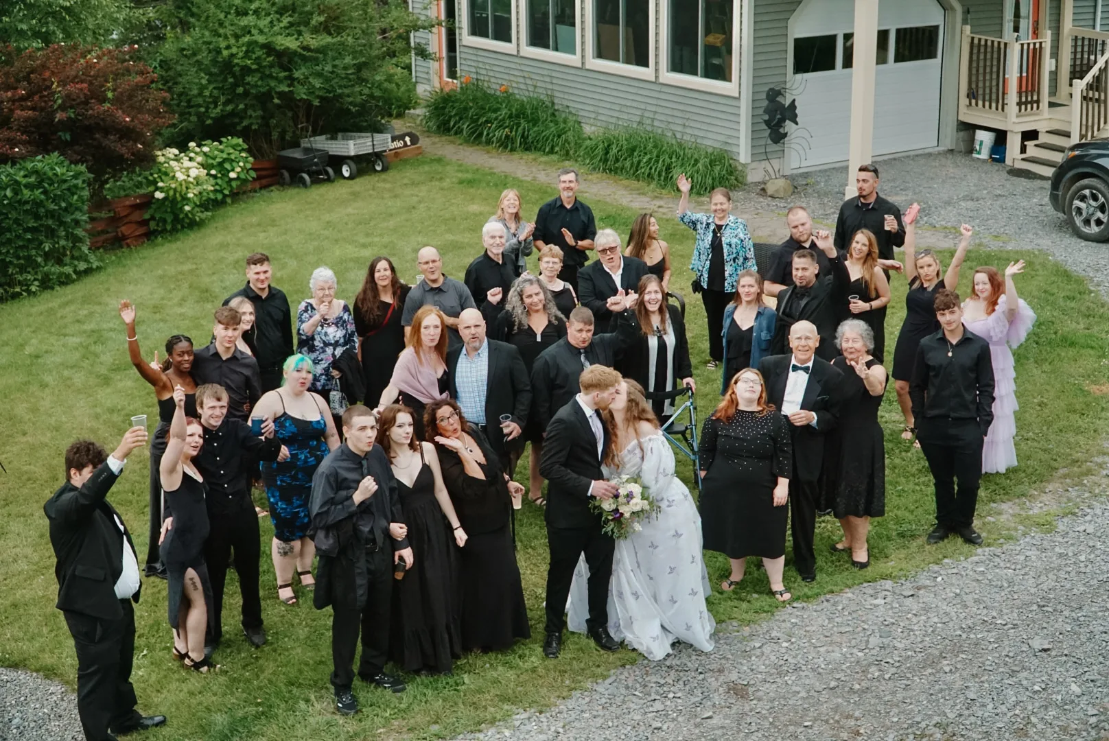 A full wedding celebration gathered outside the Main House