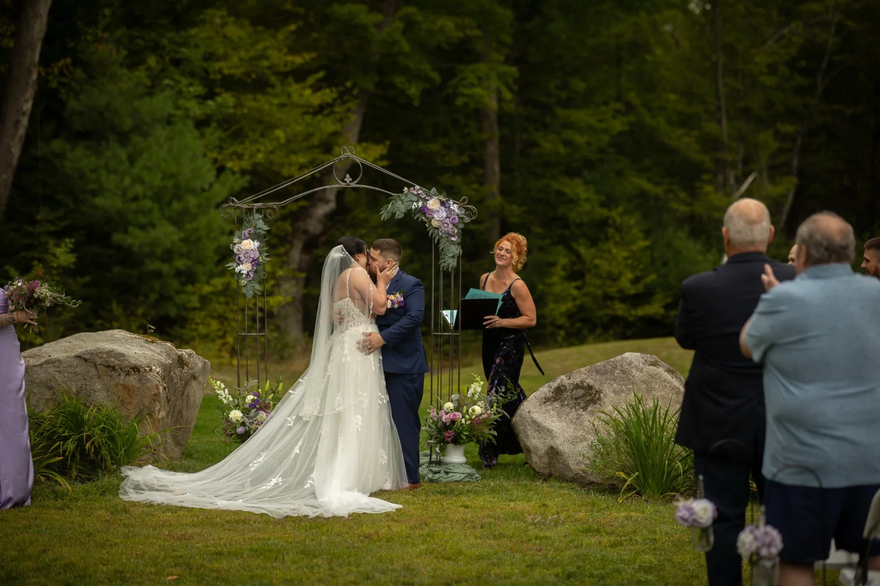 A Dragonwood couple kissing during their outdoor ceremony