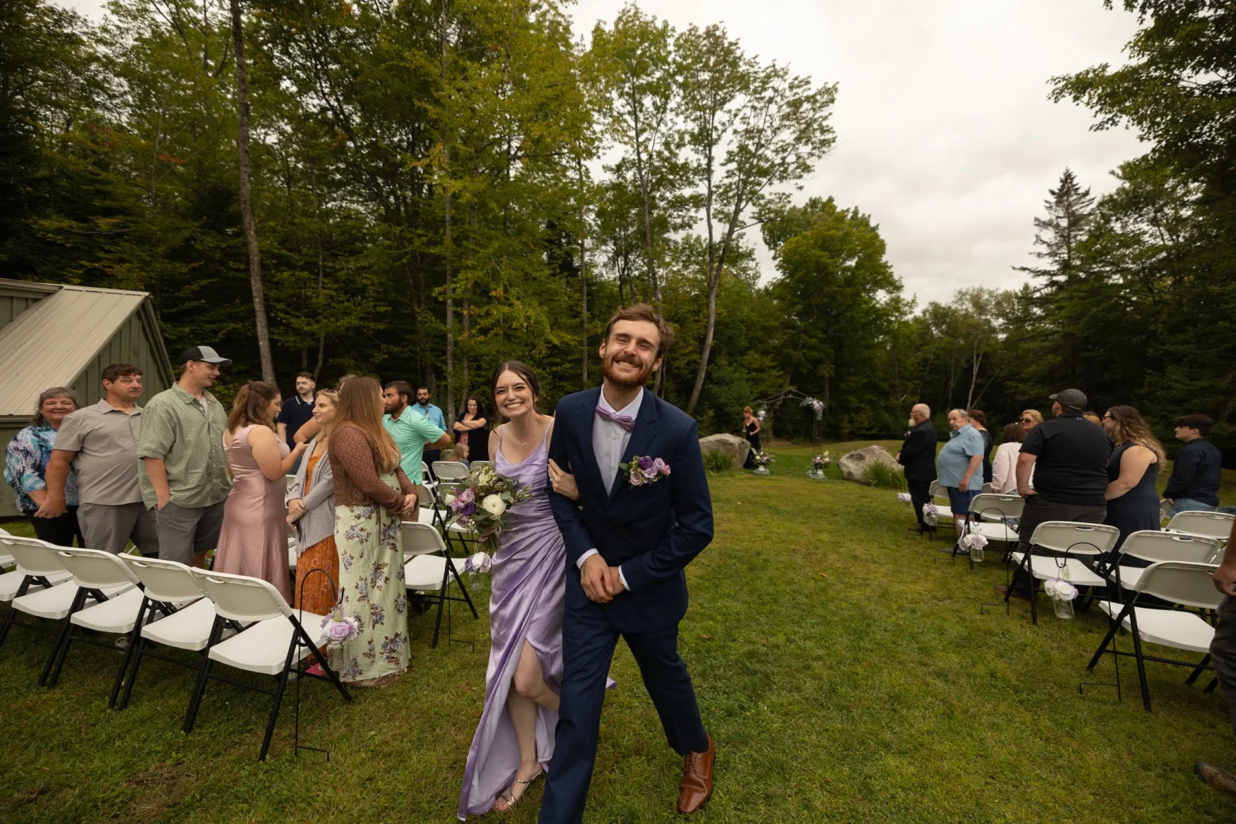 Wedding processional crossing the lawn at Dragonwood