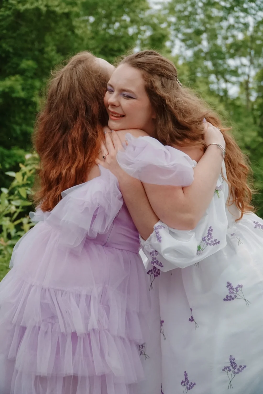 A wedding party sharing a group hug at Dragonwood