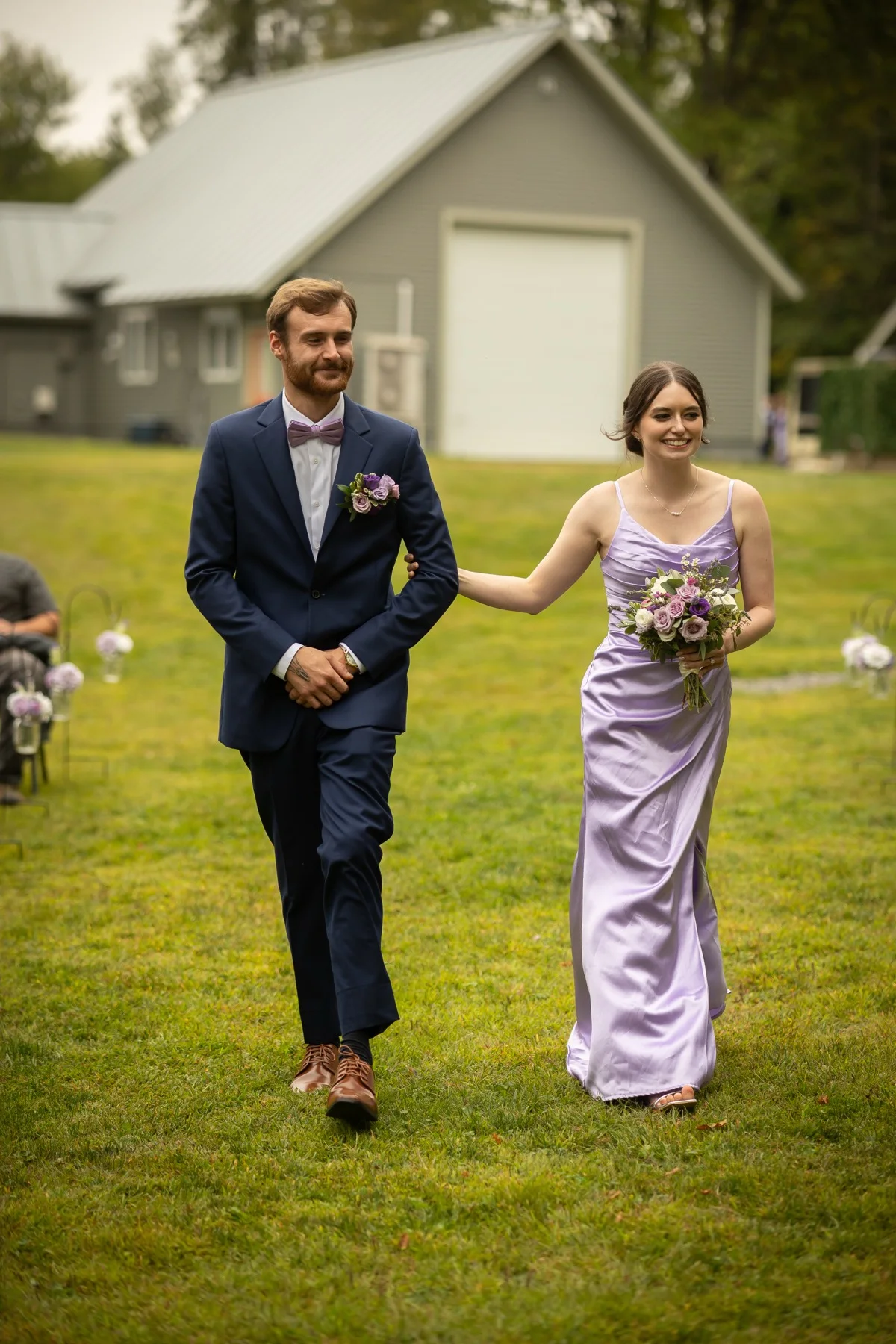 Members of a wedding party walking together across the lawn